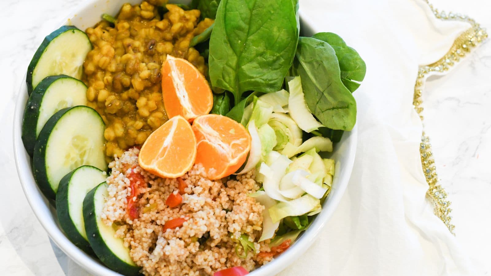 ceramic bowl of spinach leaves and lentils in soft daylight